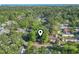 A bird's-eye view of cozy gray mobile home nestled among lush trees and surrounding community at 103 Off Shore Dr., Murrells Inlet, SC 29576