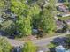 Aerial view of a charming gray mobile home nestled among lush trees and beautiful landscape, ideal for simple living at 103 Off Shore Dr., Murrells Inlet, SC 29576