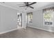 Bright bedroom with hardwood floors, ceiling fan, and two windows at 103 Off Shore Dr., Murrells Inlet, SC 29576