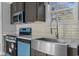Close-up of the kitchen featuring modern appliances and a stainless steel farmhouse sink at 103 Off Shore Dr., Murrells Inlet, SC 29576