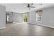Bright living room features hardwood floors and sliding glass door access to backyard at 103 Off Shore Dr., Murrells Inlet, SC 29576