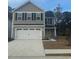 Charming two-story home with gray siding, a white garage door, and a well-maintained front yard at 1037 Oak Meadow Dr., Conway, SC 29526