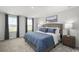 Serene primary bedroom with large windows, plush carpeting, and a comfortable bed with stylish bedding at 1037 Oak Meadow Dr., Conway, SC 29526