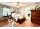 Cozy bedroom with hardwood floors, natural light, and classic furnishings at 106 Jessamine St., Andrews, SC 29510