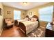 Comfortable bedroom with two twin beds, wood flooring, and a comfortable armchair next to the window at 106 Jessamine St., Andrews, SC 29510