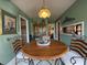 Quaint breakfast nook featuring a round wooden table, decorative lighting, and comfortable seating at 106 Jessamine St., Andrews, SC 29510