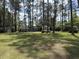 Well-maintained home with a large, verdant front yard and mature trees providing ample shade and privacy at 106 Jessamine St., Andrews, SC 29510