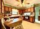 Cozy eat-in kitchen with warm wood cabinets, brick accents, ample counter space, and modern appliances at 106 Jessamine St., Andrews, SC 29510