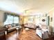 Bright and airy living room features hardwood floors, ceiling fan, neutral color palette, and comfortable seating at 106 Jessamine St., Andrews, SC 29510