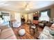Spacious living room with hardwood floors, ceiling fan, natural lighting, and comfortable seating arrangements at 106 Jessamine St., Andrews, SC 29510