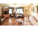 Inviting living room with hardwood floors, a ceiling fan, comfortable seating, and natural light from the windows at 106 Jessamine St., Andrews, SC 29510