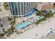 Aerial view of oceanfront condo complex with outdoor pools, splashpad, lounging areas, and beach access at 107 S Ocean Blvd. # 1201, Myrtle Beach, SC 29577
