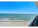 Relax on the balcony with panoramic ocean views and a sandy beach, perfect for seaside relaxation at 107 S Ocean Blvd. # 1201, Myrtle Beach, SC 29577