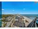 Balcony view of beach, city and pool from high rise building with blue sky at 107 S Ocean Blvd. # 1201, Myrtle Beach, SC 29577