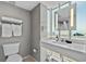 Bright bathroom features a modern vanity, toilet, and an illuminated mirror at 107 S Ocean Blvd. # 1201, Myrtle Beach, SC 29577