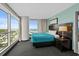 Bedroom with stunning views from large windows and sleek, contemporary furnishings at 107 S Ocean Blvd. # 1201, Myrtle Beach, SC 29577