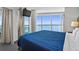 Bright bedroom features a large window with views and a comfortable queen bed at 107 S Ocean Blvd. # 1201, Myrtle Beach, SC 29577