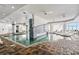 Spacious indoor pool and spa area with tile flooring, lounge chairs and a view of the coast at 107 S Ocean Blvd. # 1201, Myrtle Beach, SC 29577