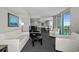 Bright living room with balcony access and ocean views features modern white furniture and gray carpeting at 107 S Ocean Blvd. # 1201, Myrtle Beach, SC 29577