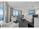 Bright living room with balcony access and ocean views features modern white furniture and gray carpeting at 107 S Ocean Blvd. # 1201, Myrtle Beach, SC 29577