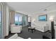 Bright living room with balcony access and ocean views features modern white furniture and gray carpeting at 107 S Ocean Blvd. # 1201, Myrtle Beach, SC 29577