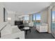 Bright living room with balcony access and ocean views features modern white furniture and gray carpeting at 107 S Ocean Blvd. # 1201, Myrtle Beach, SC 29577
