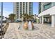 Gathering-friendly splashpad area with beach-themed design including palm trees, slides, water features, and lounge seating at 107 S Ocean Blvd. # 1201, Myrtle Beach, SC 29577