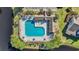 Overhead view of a pristine community pool complete with lounge chairs, tables, and palm trees creating a relaxing escape at 1098 Stanton Pl., Myrtle Beach, SC 29579