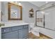 Bathroom with white vanity, marble countertop, framed mirror, and walk-in shower with glass door at 1098 Stanton Pl., Myrtle Beach, SC 29579