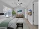 Spacious bedroom with ceiling fan, view to a queen-size bed, bench, and modern decor at 1098 Stanton Pl., Myrtle Beach, SC 29579