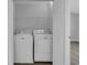Laundry room with white washer and dryer, wire shelving, and view to the bedroom at 1098 Stanton Pl., Myrtle Beach, SC 29579