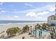 Stunning aerial view of beach, pool, and ocean at 1105 S Ocean Blvd. # 422, Myrtle Beach, SC 29577