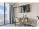 Dining area with a wooden table, chairs, and ocean view balcony access at 1105 S Ocean Blvd. # 422, Myrtle Beach, SC 29577