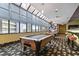 Billiard room featuring two pool tables, bar seating, and bright natural light at 1105 S Ocean Blvd. # 422, Myrtle Beach, SC 29577