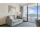 Comfortable living room featuring a cozy sofa with ocean view balcony access at 1105 S Ocean Blvd. # 422, Myrtle Beach, SC 29577