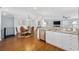 Well-equipped kitchen next to a dining area featuring stainless steel appliances, granite countertops, and white cabinets at 1114 S Dogwood Dr., Surfside Beach, SC 29575