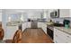 Modern kitchen with stainless steel appliances, granite countertops, white cabinetry, and hardwood floors at 1114 S Dogwood Dr., Surfside Beach, SC 29575