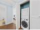 Convenient laundry area with a stackable washer and dryer; doorway leads to bathroom and bedroom at 1114 S Dogwood Dr., Surfside Beach, SC 29575