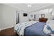Spacious main bedroom with hardwood floors, a ceiling fan, and views of the walk-in closet and ensuite bathroom at 1114 S Dogwood Dr., Surfside Beach, SC 29575