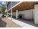 Outdoor area underneath a screened in porch with a grill and stone ground cover at 1114 S Dogwood Dr., Surfside Beach, SC 29575