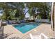 Backyard pool area surrounded by a brick patio and lounge chairs under the shade of trees at 1114 S Dogwood Dr., Surfside Beach, SC 29575