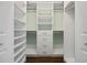 Bright walk-in closet features custom shelving and drawers for optimal storage and organization at 1114 S Dogwood Dr., Surfside Beach, SC 29575