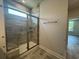 Bathroom shower with decorative tile surround and glass door at 1233 Lady Bird Way, North Myrtle Beach, SC 29582