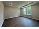 A well-lit bedroom features a tray ceiling and a large window at 1233 Lady Bird Way, North Myrtle Beach, SC 29582