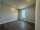 Empty bedroom with wood-look floors and natural light at 1233 Lady Bird Way, North Myrtle Beach, SC 29582