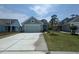 Lovely one-story home with a two-car garage, freshly poured driveway, and a well-maintained lawn at 1233 Lady Bird Way, North Myrtle Beach, SC 29582