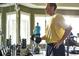 Resident working out with weights at the on-site fitness center at 1233 Lady Bird Way, North Myrtle Beach, SC 29582