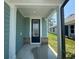 Inviting entryway with a navy blue front door framed by white columns and brick detail at 1233 Lady Bird Way, North Myrtle Beach, SC 29582