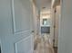 Hallway view to bathroom featuring gray cabinets and decorative mirror at 1233 Lady Bird Way, North Myrtle Beach, SC 29582