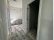 Hallway featuring an open doorway, neutral paint, tiled flooring, and base cabinets at the end at 1233 Lady Bird Way, North Myrtle Beach, SC 29582